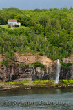 Lone house above waterfalls at Digby Gut on the North Peninsula of Annapois Basin Nova Scotia