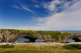 Tourist at the Arches Provincial Park Newfoundland Canada with Gulf of St. Lawrence