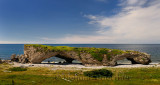 Tourists at the Arches Provincial Park Newfoundland Canada with Gulf of St. Lawrence