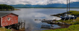Panorama of boathouse and boats at St Pauls Inlet Newfoundland with Gros Morne Long Range Mountains