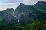 Waterfalls plunging into Western Brook Pond with steep rock cliff at Gros Morne National Park Newfoundland