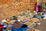 Moroccan vendors selling herbs and goods along the wall of the old Medina Casablanca