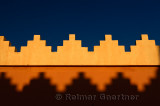 Abstract pattern of crenellations of yellow orange and blue sky Morocco