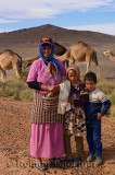 Nomadic Berber mother and children with Arabian camels Morocco