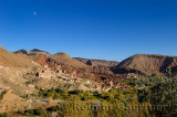 Moon in blue sky over village along Wadi Dades in Dades Gorge Morocco