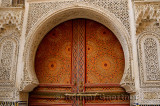 Intricate stone carving and ornate painted door of Kairaouine Mosque in Fes el Bali Medina Morocco