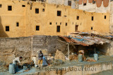 Fes leather tannery workers painting raw hides with blue chromium solution by Wadi Fes Morocco