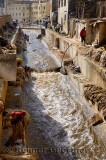 Busy Fes tannery after Eid al Adha with workers washing pelts in the Fes river Morocco