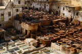 White mineral soaking vats and brown vegetable tanning pits in the Fes tannery Morocco