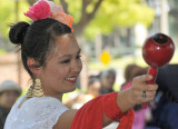 One of the dancers with maraca in hand