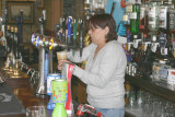 Lynn pours a pint.