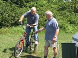 Chief mechanic waves his finger at the bike.