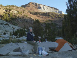 Kathy, our kitchen and tent, which we set up on a rock pedestal, the next morning.