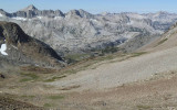 Looking west off the pass (with two hikers far below).