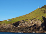 Lighthouse and building near tip of bay