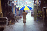 Boy With Umbrella in Heavy Rain