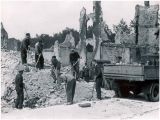 Heaps of rubble to be  cleared, truckload after truckload