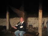 Dave warming his hands at the (unlit) fire