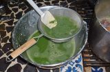 Atole de Grano: straining anicillo into soup