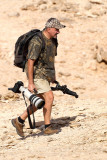 Daniele Occhiato running up and downhill following migrating raptors  over Ras Mohamed