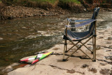 Abandoned deckchair and kite