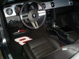 Retro styling of leather bucket seats and aluminum dash