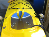 Strap/Velcro arrangements trapped under deck rigging simplify slipping the bladder inside.