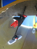 Reversed clamps push extrusions in place, keyed using a plywood insert, notched for correct angle.