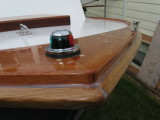 Closeup of bow light and bow chock.  Sheer guard will get white paint; toe rail, bright.