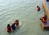 Doing puja in the Ganges with a sadhu observing, Varanasi.