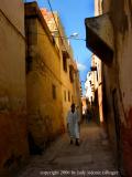 man in narrow street, rabat, morocco
