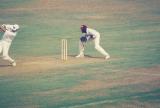 Batsman steps down the wicket to drive past the bowler