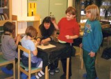 Teacher and her young  pupils learning how to mold clay