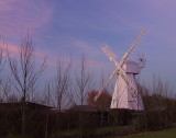 White smock mill in sunset.