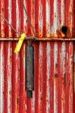 The Handle of the Red Door and the Wire with Yellow Cloth Peg
