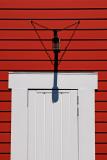 White door, red wall and lamp shadow