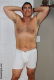 an older male model flexing shirtless arms.jpg