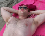 muscleman laying beach suntanning.JPG