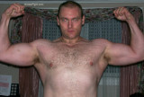 older hairy bodybuilder flexing arms.jpeg