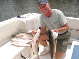 7/11/2006 - Hofmann Charter - Tom shows off nice limit of Stripers from 22 - 28 (with about 15 released)