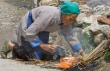 Chinese Women in Bai-village near Dali cooking her meal on the street