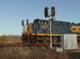 CSX 5477 through the Jones signals at sunset.  Notice the moon in the background.