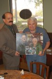Marc Gagnon and Jacques Wiesel holding art piece by Carol Morris