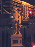 Close-up of Caesar with his arm up as if to greet guests arriving at Caesars Palace.