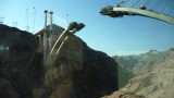 View from a bus window of a new bridge that was being constructed traversing the Black Canyon.