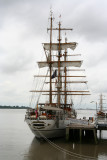 A naval instruction sailing ship docked along the pier.