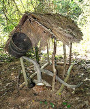 Temporary grave with plough and basket in Kachork graveyard, Cambodia.