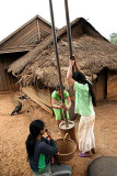 Young Phnong girls pounding rice. Dak Dam Village. Mondulkiri, Cambodia