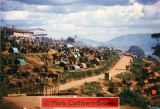 Views of the deserted part of Kibeho Camp on the road from Rwamiko. Note the complete abandonment of camp outskirts and, in particular, the movement of people on the road close to the brick structure on the right side of the road.