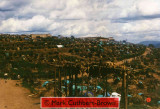 Views of the deserted part of Kibeho Camp on the road from Rwamiko. Note the complete abandonment of camp outskirts and, in particular, the movement of people on the road close to the brick structure on the right side of the road.